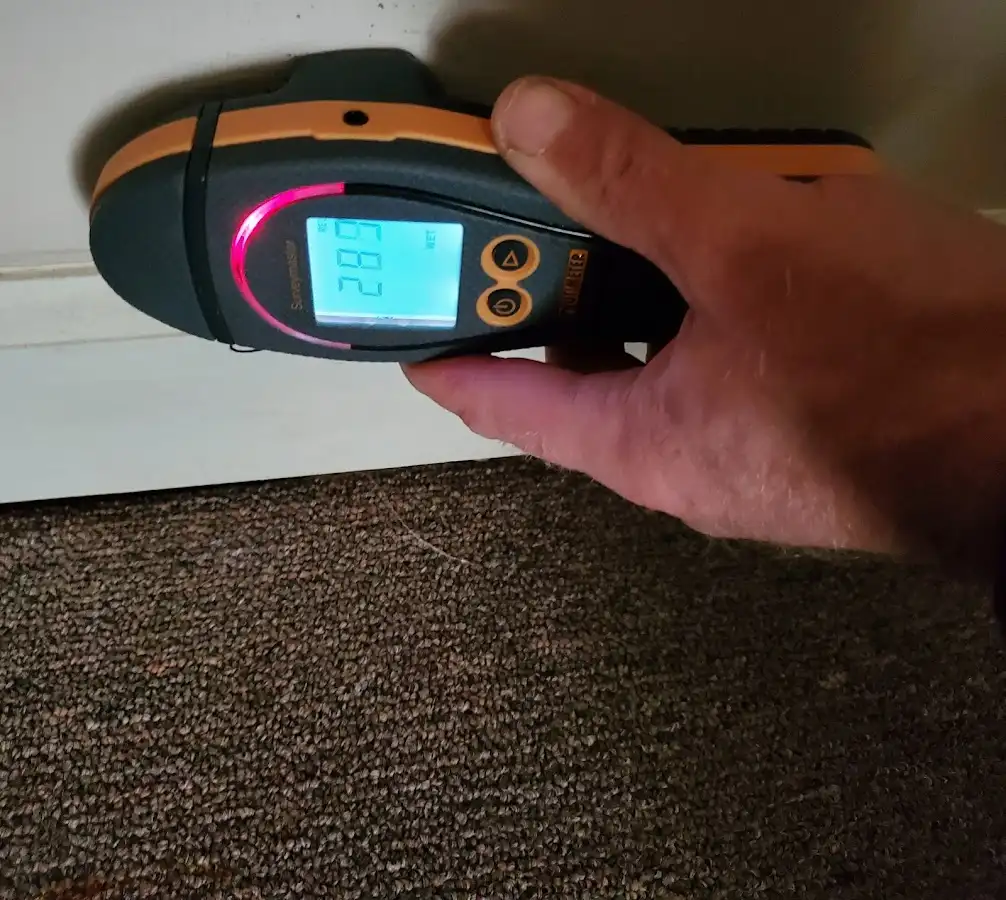 Moisture detection at baseboard during Storm Damage Restoration in Frankfort